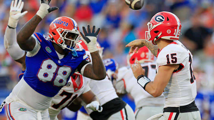 Georgia Bulldogs quarterback Carson Beck (15) is pressured by Florida Gators defensive lineman Caleb Banks (88) during the third quarter of an NCAA football game Saturday, Oct. 28, 2023 at EverBank Stadium in Jacksonville, Fla. Georgia defeated Florida 43-20.