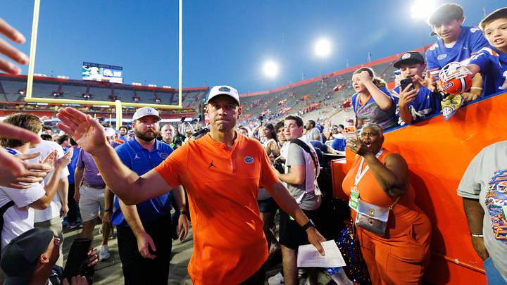 Sep 26, 2026; Gainesville, Florida, USA; Florida Gators head coach Jon Sumrall shakes hands while entering the team tunnel after a game against the Mississippi Rebels at Ben Hill Griffin Stadium. Mandatory Credit: Matt Pendleton-Imagn Images