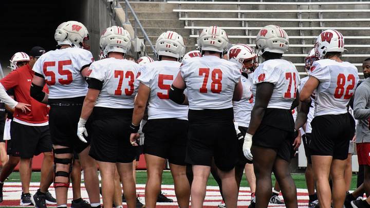Wisconsin football's offensive line huddles up during fall camp. Wisconsin football's offensive line huddles up during fall camp.