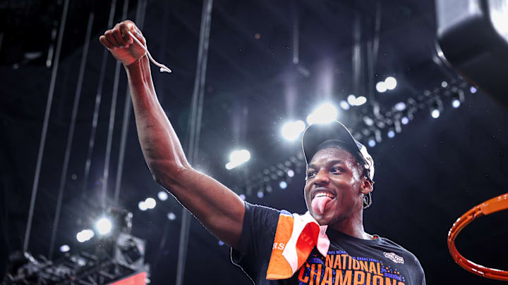 Center Rueben Chinyelu cuts down part of the net after the Florida Gators' win over Houston in the national championship. Center Rueben Chinyelu cuts down part of the net after the Florida Gators' win over Houston in the national championship.