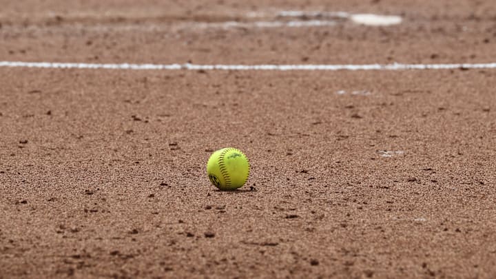 The softball lands just outside the circle between innings of the Sooners' contest against Kentucky at Love's Field.