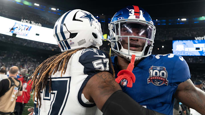 Sep 26, 2024; East Rutherford, NJ, US; New York Giants safety Tyler Nubin (31) embraces Dallas Cowboys linebacker Buddy Johnson (57) following the end of the game at MetLife Stadium.  