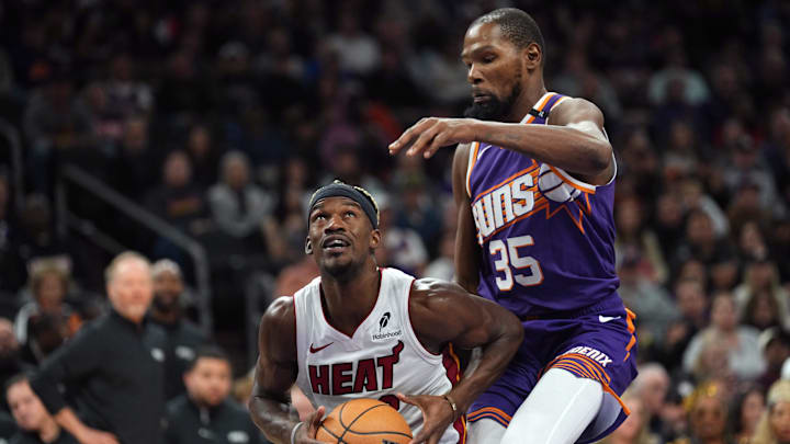 Nov 6, 2024; Phoenix, Arizona, USA; Miami Heat forward Jimmy Butler (22) drives against Phoenix Suns forward Kevin Durant (35) during the second half at Footprint Center. Mandatory Credit: Joe Camporeale-Imagn Images