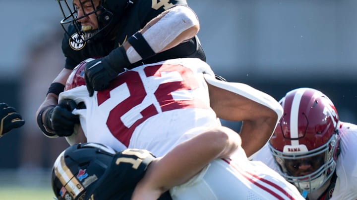 Alabama Crimson Tide running back Justice Haynes (22) is brought down by Vanderbilt Commodores linebacker Langston Patterson (10) and Vanderbilt Commodores linebacker Bryan Longwell (4) during their game at Vanderbilt Stadium in Nashville, Tenn., Saturday, Oct. 5, 2024.