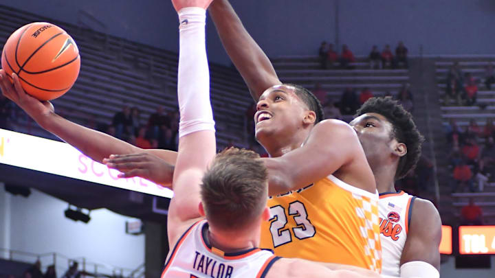 Nov 8, 2023; Syracuse, New York, USA; Canisius Golden Griffins forward Frank Mitchell (23) takes a shot as Syracuse Orange guard Justin Taylor (5) and center Naheem McLeod defend in the first half at the JMA Wireless Dome. Mandatory Credit: Mark Konezny-Imagn Images