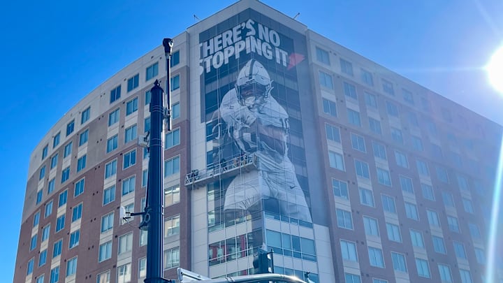 Penn State running back Nicholas Singleton is pictured on a building in downtown State College.
