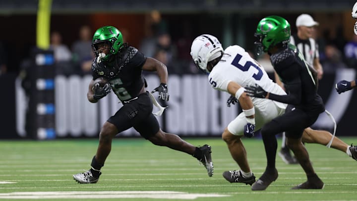 Dec 7, 2024; Indianapolis, IN, USA; Oregon Ducks running back Noah Whittington (6) runs for a gain against the Penn State Nittany Lions during the fourth quarter in the 2024 Big Ten Championship.