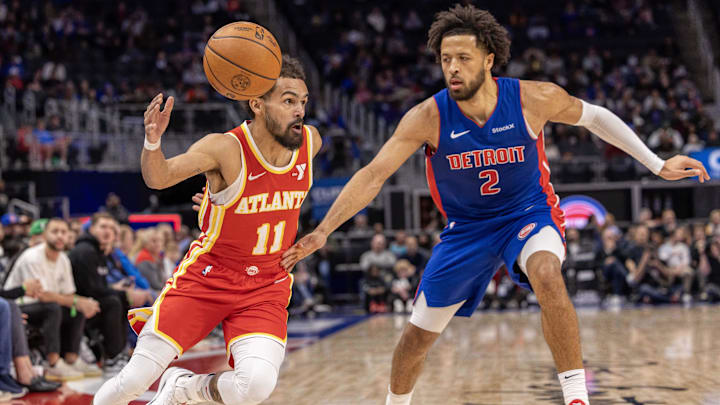 Nov 8, 2024; Detroit, Michigan, USA; Atlanta Hawks guard Trae Young (11) drives to the basket as Detroit Pistons guard Cade Cunningham (2) defends during the in the first half at Little Caesars Arena. Mandatory Credit: David Reginek-Imagn Images