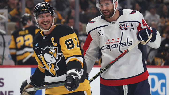 Apr 17, 2025; Pittsburgh, Pennsylvania, USA;  Washington Capitals right wing Tom Wilson (43) and Pittsburgh Penguins center Sidney Crosby (87) share a laugh during the first period at PPG Paints Arena. Mandatory Credit: Charles LeClaire-Imagn Images