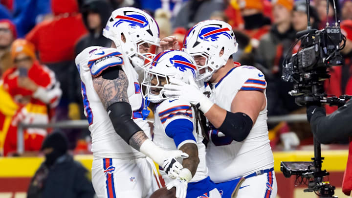 Jan 26, 2025; Kansas City, MO, USA; Buffalo Bills running back James Cook (4) celebrates with offensive tackle Spencer Brown (79) and guard Connor McGovern (66) after rushing for a touchdown against the Kansas City Chiefs during the first half in the AFC Championship game at GEHA Field at Arrowhead Stadium. 