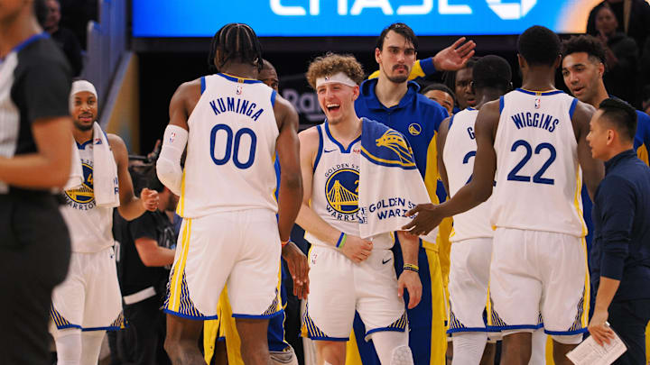 Golden State Warriors guard Brandin Podziemski (2) celebrates with forward Jonathan Kuminga (00) after a time out is called against the Portland Trail Blazers during the fourth quarter at Chase Center. Mandatory Credit: Kelley L Cox-Imagn Images