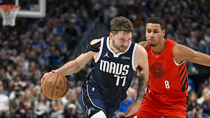 Jan 3, 2024; Dallas, Texas, USA; Dallas Mavericks guard Luka Doncic (77) drives to the basket past Portland Trail Blazers forward Kris Murray (8) during the second half at the American Airlines Center. Mandatory Credit: Jerome Miron-Imagn Images