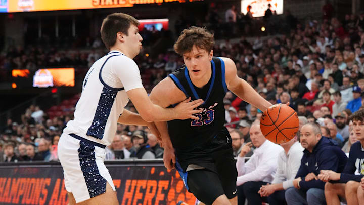 Wisconsin Lutheran's Zavier Zens (23) breaks around Appleton North's Nathan Ramus (4) during their WIAA Division 1 state semifinal basketball game on Friday, March 20, 2026, at the Kohl Center in Madison, Wisconsin.