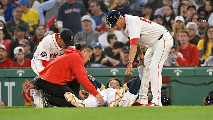 May 2, 2025; Boston, Massachusetts, USA; Boston Red Sox first baseman Triston Casas (36) is attended to by coaching and medical staff during the second inning against the Minnesota Twins at Fenway Park. Mandatory Credit: Eric Canha-Imagn Images