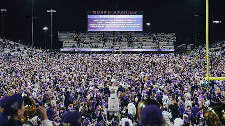 Husky fans rush the field to celebrate beating Michigan. Husky fans rush the field to celebrate beating Michigan.