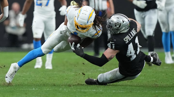 Jan 5, 2025; Paradise, Nevada, USA; Los Angeles Chargers wide receiver Quentin Johnston (1) catches the ball against Las Vegas Raiders linebacker Robert Spillane (41) in the first half at Allegiant Stadium. Mandatory Credit: Kirby Lee-Imagn Images