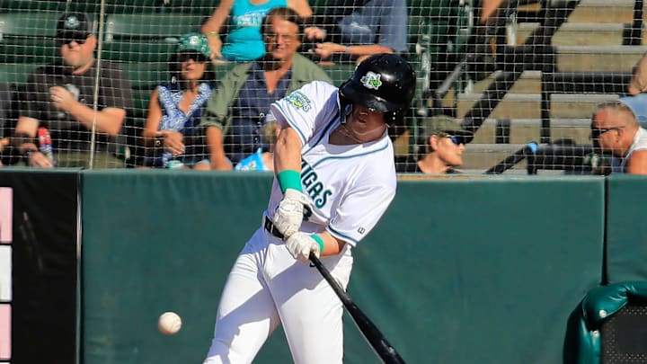 Outfielder (13)  Ethan O'Donnell makes a home run hit and scores  the first point of the game.