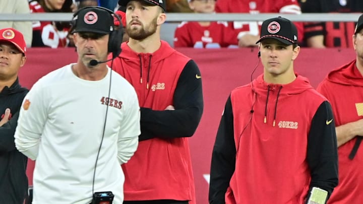 Jan 5, 2025; Glendale, Arizona, USA;  San Francisco 49ers quarterback Brock Purdy (right) and head coach Kyle Shanahan (left) look on the in second half against the Arizona Cardinals at State Farm Stadium. Mandatory Credit: Matt Kartozian-Imagn Images