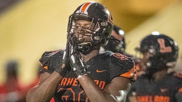 Lakeland Dreadnaughts (99) Gabriel Dindy celebrates a sack of Manatee High School quarterback (11) Jayse Berzowski in first half action at Bryant Stadium in Lakeland  Fl. Friday Sept. 3 2021