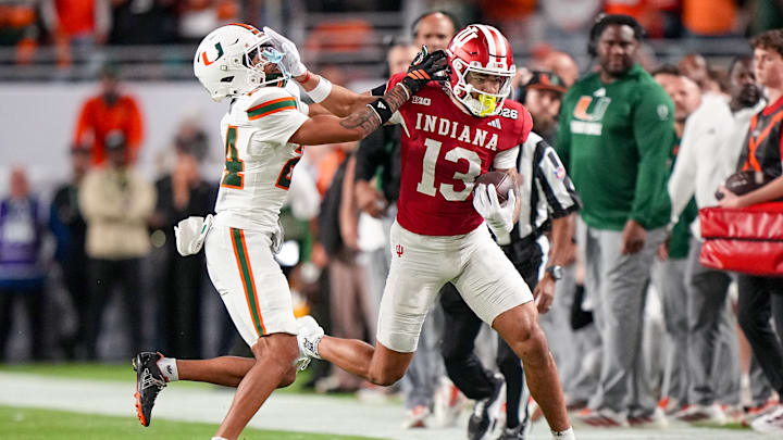 Indiana Hoosiers wide receiver Elijah Sarratt stiff-arms a Miami Hurricanes defender during the College Football Playoff national championship game.