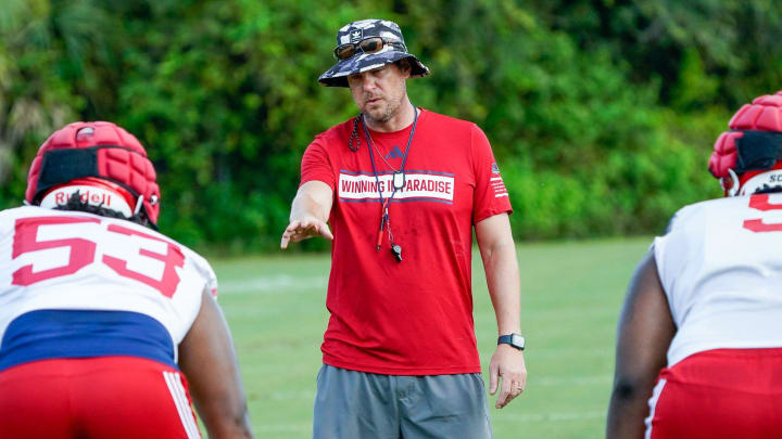 Florida Atlantic head coach Tom Herman works with the defense during practice at the Schmidt Family Complex in Boca Raton.