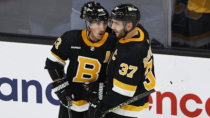 Boston Bruins center Patrice Bergeron congratulates left wing Brad Marchand after he scored against the Detroit Red Wings.