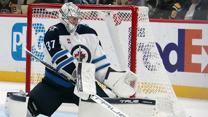 Nov 22, 2024; Pittsburgh, Pennsylvania, USA; Winnipeg Jets goaltender Connor Hellebuyck (37) makes as save against the Pittsburgh Penguins during the third period at PPG Paints Arena. Mandatory Credit: Charles LeClaire-Imagn Images