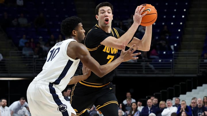 Feb 28, 2026; University Park, Pennsylvania, USA; Iowa Hawkeyes forward Alvaro Folgueiras (7) moves with the ball as Penn State Nittany Lions forward Josh Reed (10) defends during the second half at Bryce Jordan Center. Mandatory Credit: Matthew O'Haren-Imagn Images