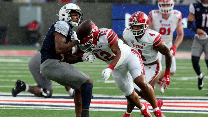 Nov 18, 2023; Tucson, Arizona, USA; Utah Utes linebacker Sione Fotu (12) knocks the ball loose from Arizona Wildcats wide receiver Montana Lemonious-Craig (5) during the second half at Arizona Stadium. Mandatory Credit: Zachary BonDurant-USA TODAY Sports Nov 18, 2023; Tucson, Arizona, USA; Utah Utes linebacker Sione Fotu (12) knocks the ball loose from Arizona Wildcats wide receiver Montana Lemonious-Craig (5) during the second half at Arizona Stadium. Mandatory Credit: Zachary BonDurant-USA TODAY Sports