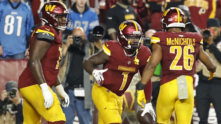 Nov 9, 2025; Landover, Maryland, USA; Washington Commanders wide receiver Robbie Chosen (12) celebrates with Commanders running back Jeremy McNichols (26) after catching a touchdown pass against the Detroit Lions in the third quarter at Northwest Stadium. Mandatory Credit: Geoff Burke-Imagn Images