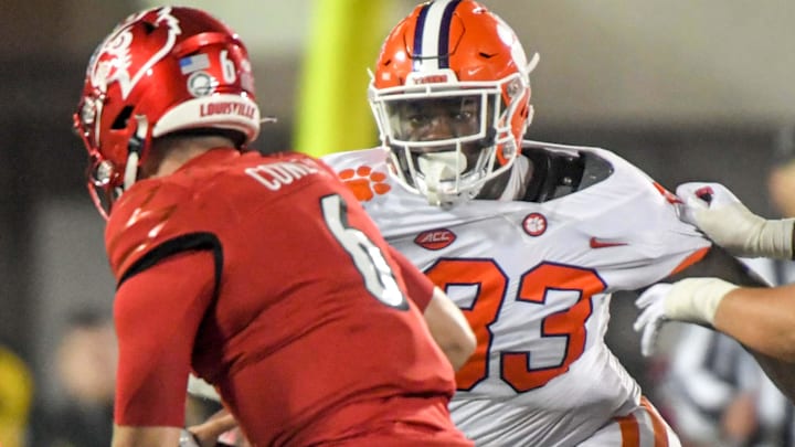 Clemson defensive tackle Ruke Orhorhoro (33) pressures Louisville quarterback Evan Conley (6) during
