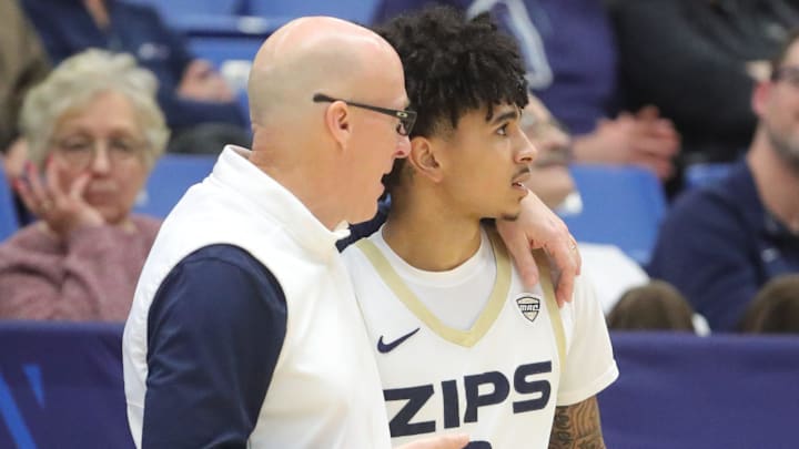 University of Akron head coach John Groce talks with Sharron Young