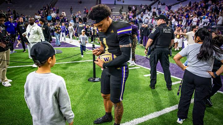 Demond Williams Jr. signs an autograph for a young fan. Demond Williams Jr. signs an autograph for a young fan.