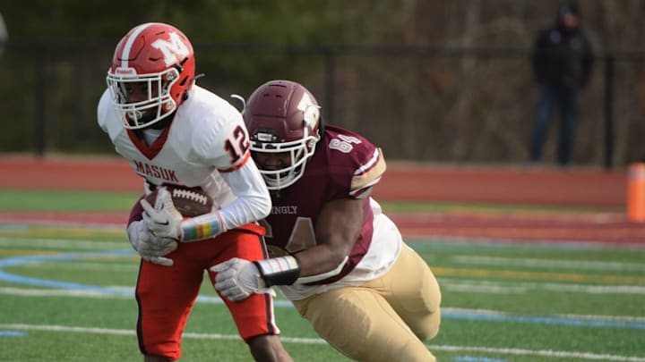 Killingly senior Terrence Allen makes the tackle against Masuk's Gavin Walker during the CIAC Class MM semifinal Sunday at Morgan Field.

Allen