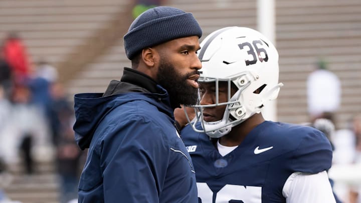 Penn State defensive line coach Deion Barnes greets defensive end Zuriah Fisher before the start of a Nittany Lions game at Beaver Stadium.