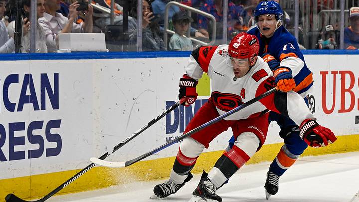 Apr 14, 2026; Elmont, New York, USA;  New York Islanders right wing Victor Eklund (73) defends against Carolina Hurricanes left wing Jordan Martinook (48) during the third period at UBS Arena. Mandatory Credit: Dennis Schneidler-Imagn Images