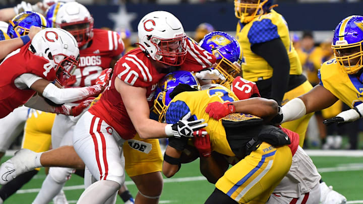 Carthage's Colt Hodges (70) and Jaydon Lewis (5) tackle Waco La Vega's Elbert Jones during the 4A DII UIL Texas State Football Championship game on Friday, December 20, 2024 at AT&T Stadium in Arlington.