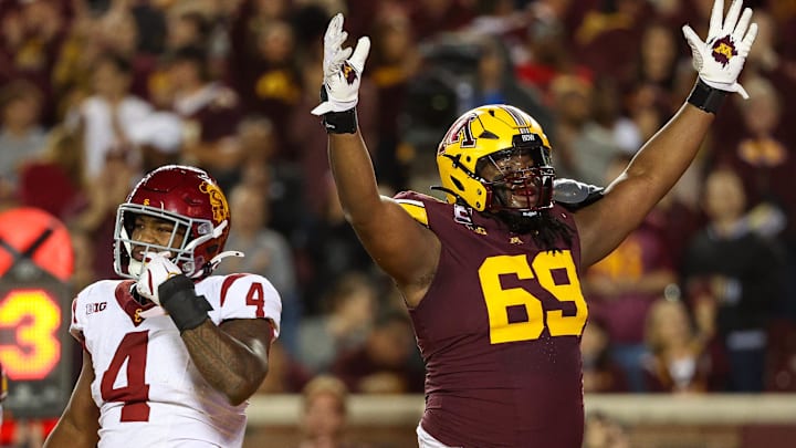 Oct 5, 2024; Minneapolis, Minnesota, USA; Minnesota Golden Gophers offensive lineman Aireontae Ersery (69) celebrates quarterback Max Brosmer's (16) touchdown against the USC Trojans during the first half at Huntington Bank Stadium. Mandatory Credit: Matt Krohn-Imagn Images