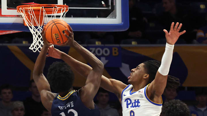 Nov 23, 2025; Pittsburgh, Pennsylvania, USA;  Pittsburgh Panthers guard Omari Witherspoon (8) fouls Quinnipiac Bobcats forward Spence Wewe (12) during the first half against at the Petersen Events Center. Mandatory Credit: Charles LeClaire-Imagn Images