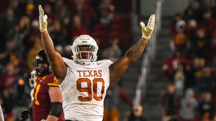 Texas Longhorns defensive lineman Byron Murphy II (90) celebrates sacking Iowa State quarterback Rocco Becht (3) during the game at Jack Trice Stadium on Saturday, Nov. 8, 2023 in Ames, Iowa. Texas Longhorns defensive lineman Byron Murphy II (90) celebrates sacking Iowa State quarterback Rocco Becht (3) during the game at Jack Trice Stadium on Saturday, Nov. 8, 2023 in Ames, Iowa.