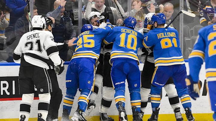 Mar 1, 2025; St. Louis, Missouri, USA;  St. Louis Blues center Jordan Kyrou (25) and Los Angeles Kings defenseman Jacob Moverare (43) fight during the third period at Enterprise Center. Mandatory Credit: Jeff Curry-Imagn Images