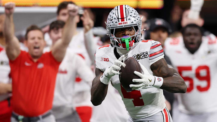 Jan 20, 2025; Atlanta, GA, USA; Ohio State Buckeyes wide receiver Jeremiah Smith (4) makes a catch against the Notre Dame Fighting Irish during the second half the CFP National Championship college football game at Mercedes-Benz Stadium. Mandatory Credit: Brett Davis-Imagn Images Jan 20, 2025; Atlanta, GA, USA; Ohio State Buckeyes wide receiver Jeremiah Smith (4) makes a catch against the Notre Dame Fighting Irish during the second half the CFP National Championship college football game at Mercedes-Benz Stadium. Mandatory Credit: Brett Davis-Imagn Images
