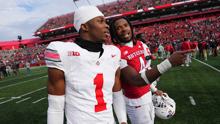 Nov 4, 2023; Piscataway, New Jersey, USA; Ohio State Buckeyes cornerback Davison Igbinosun (1) talks to his brother, Rutgers Scarlet Knights defensive back Desmond Igbinosun (4), following the NCAA football game at SHI Stadium. 