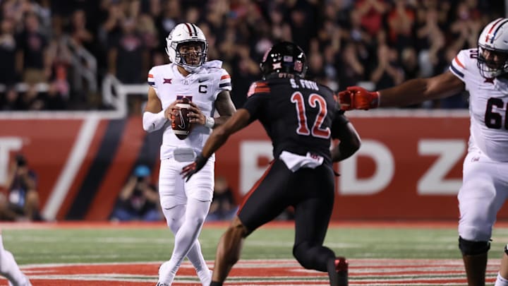 Sep 28, 2024; Salt Lake City, Utah, USA; Arizona Wildcats quarterback Noah Fifita (11) looks to pass against Utah Utes linebacker Sione Fotu (12) during the first quarter at Rice-Eccles Stadium.