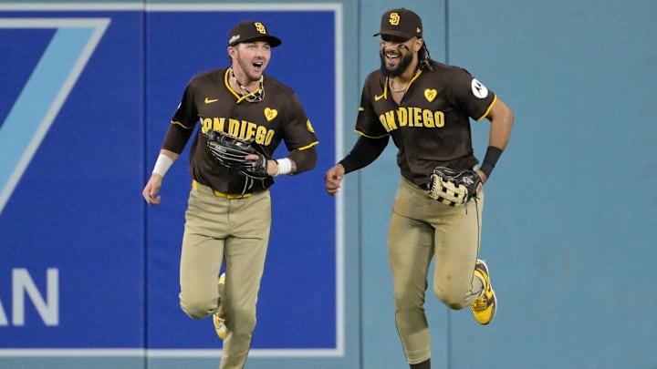 Oct 6, 2024; Los Angeles, California, USA; San Diego Padres outfielder Jackson Merrill (3) and outfielder Fernando Tatis Jr. (23) react in the sixth inning against the Los Angeles Dodgers during game two of the NLDS for the 2024 MLB Playoffs at Dodger Stadium. Mandatory Credit: Jayne Kamin-Oncea-Imagn Images