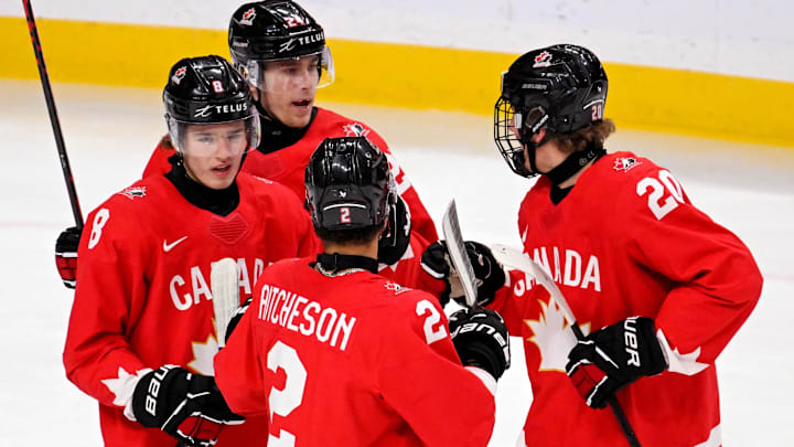 Jan 5, 2026; St. Paul, Minnesota, USA; Canada forward Braeden Cootes (8) celebrates his goal against Finland with forward Liam Greentree (24), defensemen Kashawn Aitcheson (2), and defensemen Keaton Verhoeff (20) during the first period in the third place game of the 2026 IIHF World Junior Championship ice hockey tournament at Grand Casino Arena. Mandatory Credit: Nick Wosika-Imagn Images