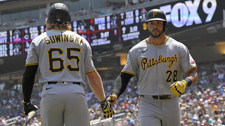 Jul 13, 2025; Minneapolis, Minnesota, USA;  Pittsburgh Pirates outfielder Tommy Pham (28) celebrates his solo home run against the Minnesota Twins with outfielder Jack Suwinski (65) during the second inning at Target Field. Mandatory Credit: Nick Wosika-Imagn Images