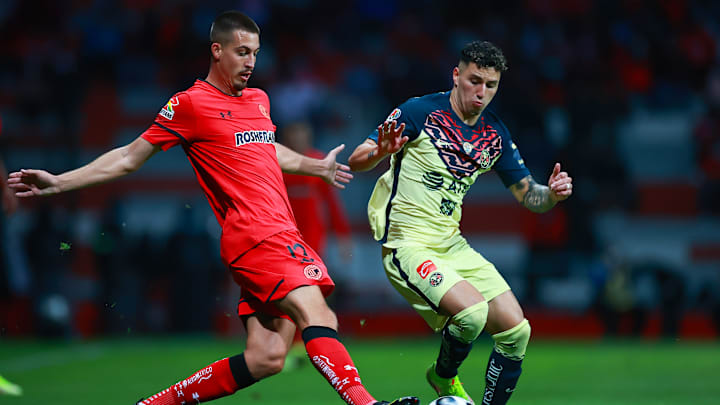 Ian González y Jorge Sánchez pelean un balón.