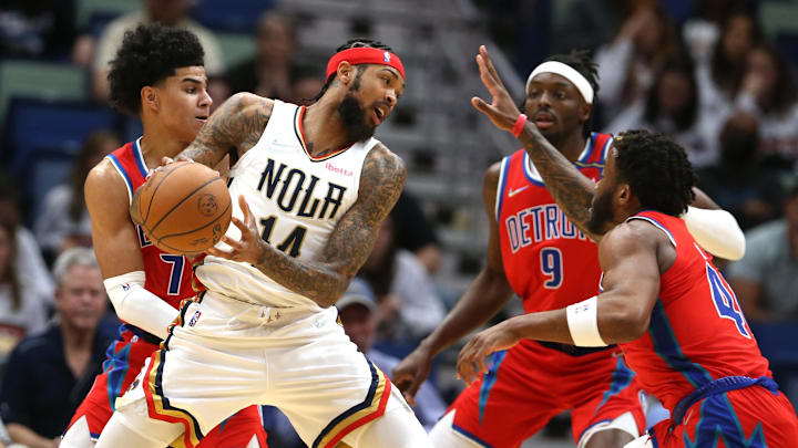 Dec 10, 2021; New Orleans, Louisiana, USA; New Orleans Pelicans forward Brandon Ingram (14) is defended by Detroit Pistons guard Killian Hayes (7) and forwards Jerami Grant (9) and Saddiq Bey (41) in the first quarter at the Smoothie King Center. Mandatory Credit: Chuck Cook-Imagn Images