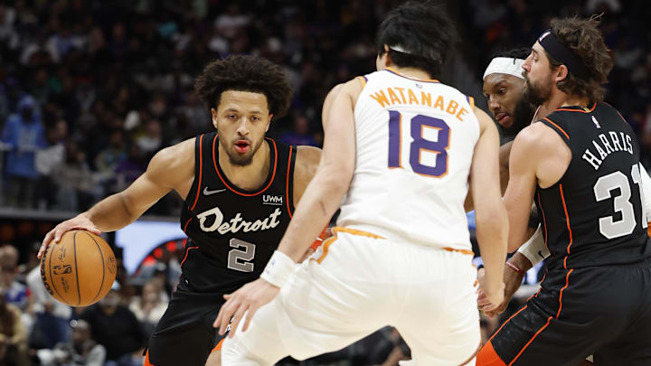 Nov 5, 2023; Detroit, Michigan, USA;  Detroit Pistons guard Cade Cunningham (2) dribbles defended by Phoenix Suns forward Yuta Watanabe (18) in the second half at Little Caesars Arena. Mandatory Credit: Rick Osentoski-Imagn Images